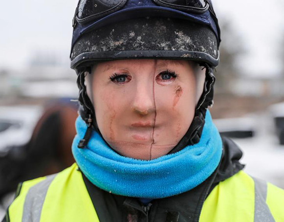  Trainer Lawney Hill poses for a photograph as she wears tights over her face to keep out the cold after taking her horses out on the all-weather gallops in Tetsworth, Britain, March 2, 2018. Photo by Eddie Keogh 